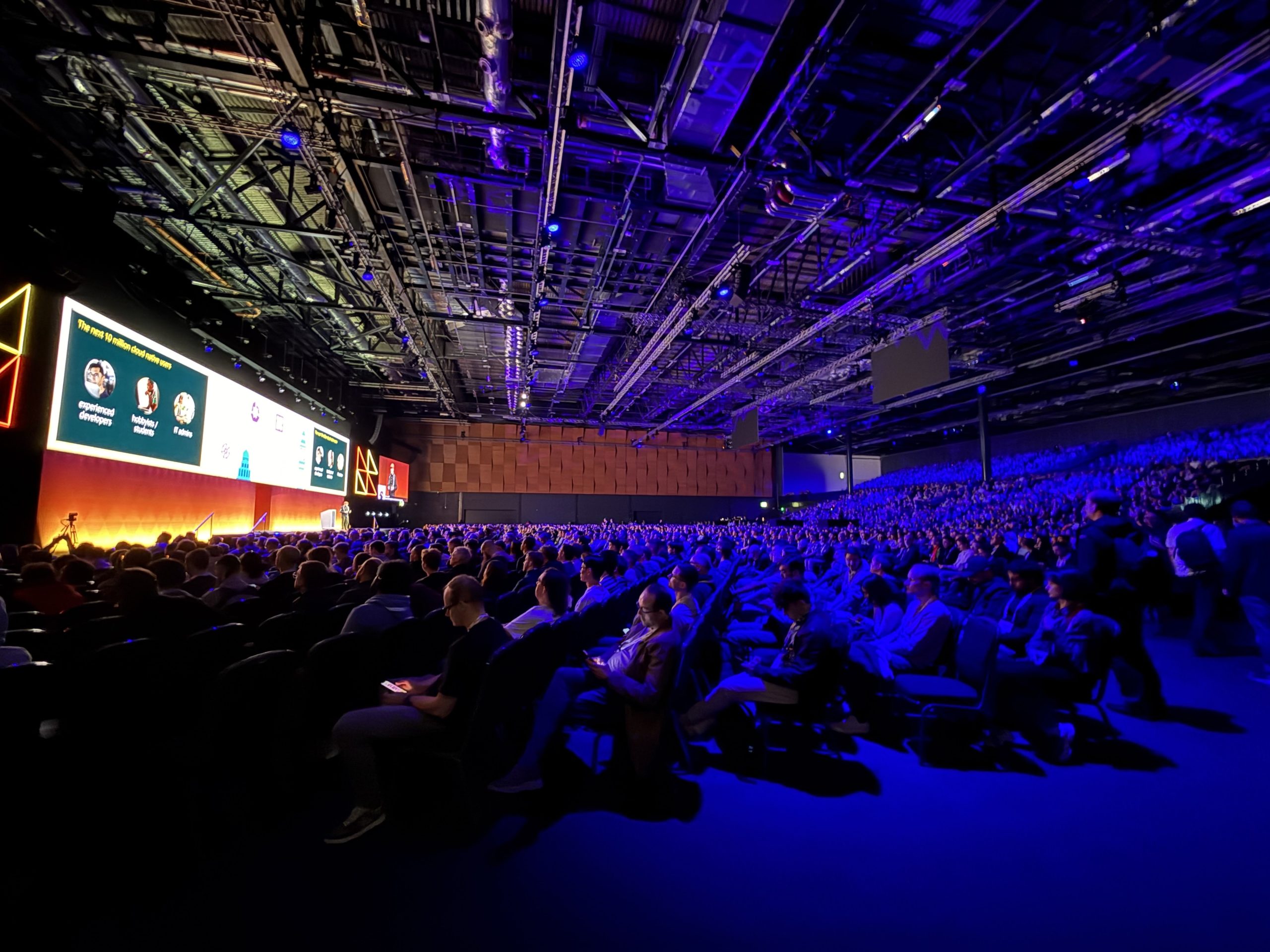 Photo of a large crowd watching the keynote stage at KubeCon EU 2025